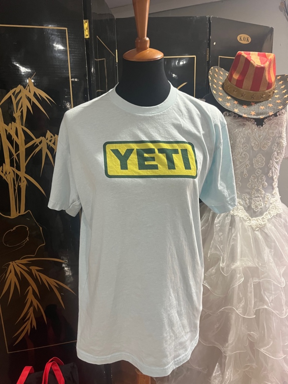 Yeti Light Blue Short Sleeve Logo Tee with Yellow & Green Chest Emblem